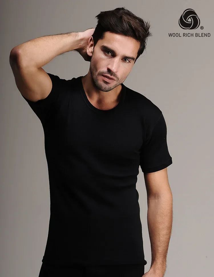 4000%20-%20Men%27s%20Black%20Short%20Sleeve%20Wool%20Undershirt%20-%204000 Black male model wearing Wool Rich Blend T-shirt, posing with hand behind head against plain background, showcasing stylish casual men's fashion from Turkey.
