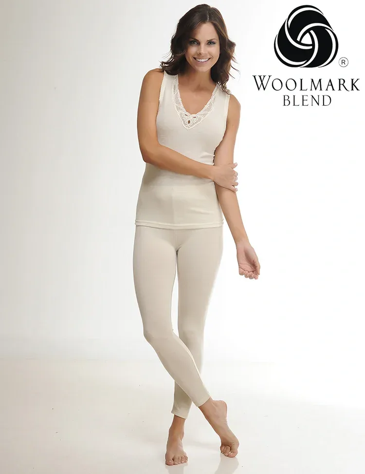 306%20-%20Women%27s%20Stretch%20Wool%20Leggings%20-%20306 Soft beige woolmark blend top and leggings set, woman smiling with crossed arms, comfortable casual loungewear, high-quality Turkish knitwear, stylish and cozy for everyday wear.