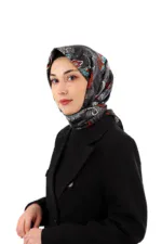 Black silk headscarf with colorful paisley patterns worn by a woman in a black suit, showcasing Turkish fashion and accessories. Perfect for stylish cultural or everyday wear.