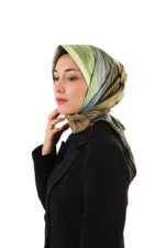 Elegant woman wearing a stylish, colorful silk scarf with shades of green, beige, and black, paired with a black blazer for a sophisticated look, showcasing Turkish fashion products.