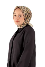 Smooth beige and black patterned silk scarf styled as a hijab, draped over a woman's head.