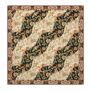 Vivid floral patterned Turkish rug with black, beige, and orange motifs, showcasing traditional craftsmanship and intricate details for elegant home decor.