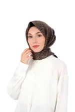 Sophisticated brown patterned silk hijab styled on a woman with a white blouse, perfect for elegant everyday wear or special occasions.