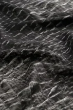 Vegan leather fabric with a textured, grid-like pattern in black and white, showcasing durable and stylish material for fashion and accessories.