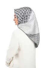 Elegant black and white patterned silk hijab with striped and geometric designs, perfect for fashionable modest wear.
