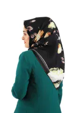 Elegant floral hijab with black background and beige, white, and pink flowers, paired with a teal blazer for a sophisticated look. Perfect for stylish modest fashion and daily wear.