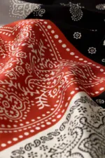 Vibrant red and black bandanas with traditional white paisley patterns, ideal for fashion accessories, cultural attire, or stylish decor. Crafted with high-quality fabric for comfort and durability.
