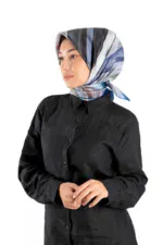 Elegant woman wearing a stylish, colorful silk scarf and black button-up shirt for a fashionable and versatile look. Perfect for work or casual outings.