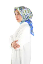 Elegant woman wearing colorful patterned hijab and white clothing, showcasing Turkish fashion and headscarves for cultural style and modesty.