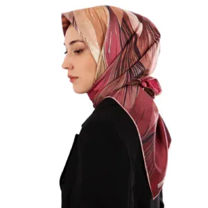 Elegant woman wearing a colorful patterned silk hijab, side profile view, stylish and modest fashion accessory.