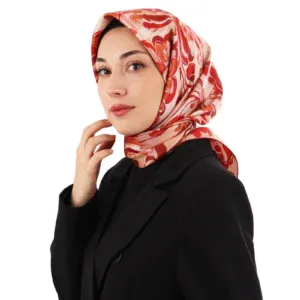 Elegant woman wearing a stylish red and white patterned silk scarf, black blazer, showcasing Turkish fashion and accessories with a sophisticated look.