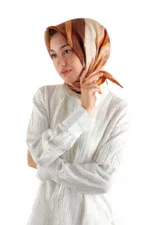 Soft woman wearing a colorful silk scarf and white shirt, looking thoughtfully to the side, promoting Turkish fashion accessories from Shop of Turkey.