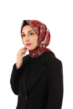 Elegant woman wearing a stylish red patterned silk hijab and black blazer, showcasing Islamic fashion accessible at Shop of Turkey for fast international shipping.
