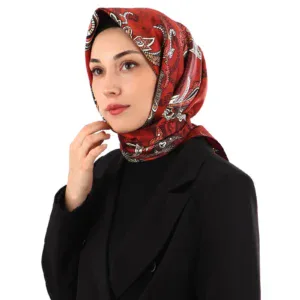 Elegant woman wearing a stylish red patterned silk hijab and black blazer, showcasing Islamic fashion accessible at Shop of Turkey for fast international shipping.