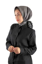 Elegant woman wearing a stylish grey satin headscarf and black shirt, showcasing Turkish fashion and modest wear on Shop of Turkey. Perfect for Turkish clothing enthusiasts.