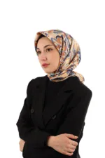 Elegant woman wearing a colorful floral silk hijab and a black blazer, showcasing Turkish fashion and accessories available at Shop of Turkey for fast shipping worldwide.