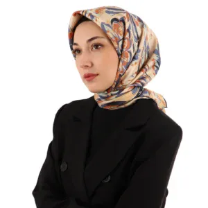 Elegant woman wearing a colorful floral silk hijab and a black blazer, showcasing Turkish fashion and accessories available at Shop of Turkey for fast shipping worldwide.
