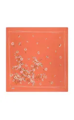 Vibrant coral-colored scarf featuring a delicate white daisy floral pattern with fluttering bees, perfect for a stylish accessory or gift from Turkey.