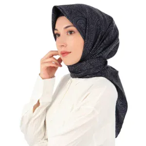 Luxurious navy blue silk hijab with intricate swirling patterns, styled elegantly on a young woman, highlighting traditional Turkish fashion accessories available at Shop of Turkey.