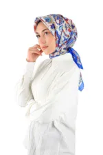 Silk scarves with intricate floral patterns in blue, red, and gold, worn as headscarves by a woman in a white outfit, showcasing traditional Turkish fashion accessories on Shop of Turkey website.