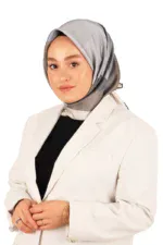 Elegant woman wearing a stylish grey hijab and white blazer, showcasing modest fashion and accessories, promoting Turkish clothing and accessories at Shop of Turkey.