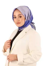 Vibrant blue and gray patterned silk hijab styled elegantly by a woman in a white blazer for a fashionable modest look.