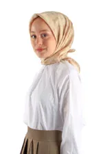 Soft beige silk hijab with subtle monogram pattern, draped elegantly around a woman’s head and shoulders, showcasing Turkish fashion style available with fast shipping from Shop of Turkey.