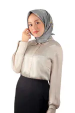 Elegant woman wearing a silk headscarf with floral patterns, beige blouse, and black skirt, showcasing modest fashion styles available at Shop of Turkey for fast Turkish product shipping.
