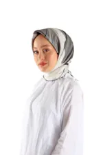 Soft gray, white, and black silk headscarf styled on a woman with a calm expression, white blouse, and makeup. Perfect for elegant modest fashion, available at Shop of Turkey for fast shipping.