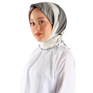 Soft gray, white, and black silk headscarf styled on a woman with a calm expression, white blouse, and makeup. Perfect for elegant modest fashion, available at Shop of Turkey for fast shipping.