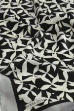 Black and white geometric patterned fabric with the label "Bursa IPQ," ideal for clothing or home decor projects.