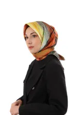 Vibrant multicolored silk headscarf styled elegantly on a woman wearing a black blazer, showcasing Turkish fashion and textile craftsmanship.
