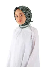 Elegant woman wearing a houndstooth patterned headscarf and white dress, representing Turkish fashion and traditional clothing available at Shop of Turkey.