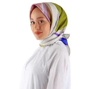 Vibrant multicolor silk hijab with floral pattern, styled on a smiling woman against a plain white background, showcasing elegant modest fashion accessories from Turkey.