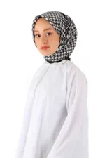 Black and white patterned hijab worn by a young woman in a white top, showcasing traditional modest fashion and high-quality Turkish textiles. Perfect for cultural pride and stylish modest dressing.