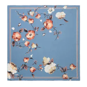 Soft pastel blue floral patterned scarf with peach and cream flowers on silk fabric, featuring delicate branch and leaf details, ideal for elegant fashion styling.