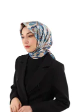 Elegant woman wearing a stylish patterned silk headscarf paired with a black blazer, showcasing Turkish fashion and accessories at Shop of Turkey for quick worldwide shipping.