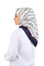 Elegant woman wearing a stylish patterned headscarf with geometric design, showcasing Turkish fashion accessories available for purchase on Shop of Turkey.