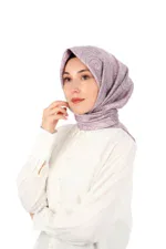 Elegant woman wearing a stylish, patterned hijab in soft lilac tones, showcasing modest fashion options from Turkey, perfect for fashionable, culturally inspired headwear.
