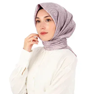 Elegant woman wearing a stylish, patterned hijab in soft lilac tones, showcasing modest fashion options from Turkey, perfect for fashionable, culturally inspired headwear.