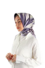 Elegant woman wearing a stylish silk scarf with purple and cream abstract patterns, paired with a white textured blouse, showcasing fashionable accessories available for quick shipping from Turkey.