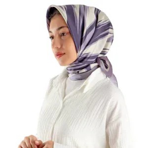 Elegant woman wearing a stylish silk scarf with purple and cream abstract patterns, paired with a white textured blouse, showcasing fashionable accessories available for quick shipping from Turkey.
