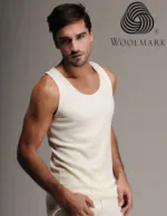 Woolmark logo on beige tank top worn by male model, fashion apparel advertisement for Woolmark products.