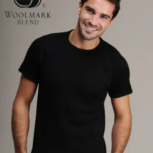 Woolmark Blend logo with a smiling man in black t-shirt, casual portrait, modern fashion, neutral background, emphasizing style and comfort.