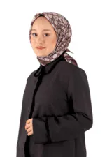 Elegant woman wearing a stylish patterned hijab and black coat, showcasing modest fashion from Turkey, suitable for cold weather and cultural attire, representing Turkish fashion and accessories.