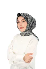 Elegant woman wearing a stylish navy blue and gold patterned silk headscarf, showcasing the popular Turkish hijab fashion, perfect for sophisticated and modest outfits worldwide.