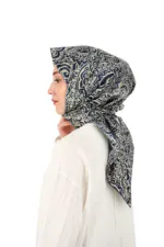 Elegant woman wearing a stylish navy and beige patterned hijab, showcasing traditional Turkish fashion with modern design. Perfect for cultural or modest fashion inspiration.