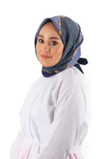 Vibrant blue patterned silk hijab worn by a smiling woman in a white chef coat, showcasing traditional Turkish fashion with modern elegance.