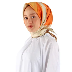 Elegant woman wearing a colorful silk hijab with shades of orange, beige, and cream, paired with a white top, showcasing Turkish fashion and accessories at Shop of Turkey for fast shipping.