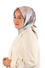 Elegant woman wearing a colorful silk hijab and a cream blazer, showcasing modest fashion from Turkey. Perfect for stylish, cultural, and sophisticated looks with fast shipping options.